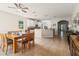 Open kitchen and dining area with tile flooring, white cabinets, and granite countertops at 2903 Cypress Bowl Rd, Lutz, FL 33558