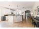 Bright kitchen with white cabinets, granite countertops, island with pendant lighting, and tiled floors at 2903 Cypress Bowl Rd, Lutz, FL 33558