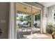 Covered patio with outdoor seating and view of the fenced backyard and greenery at 2903 Cypress Bowl Rd, Lutz, FL 33558
