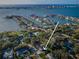 An aerial view displays a home's location within a neighborhood near a large body of water at 3165 Renatta Dr, Belleair Bluffs, FL 33770
