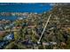 Stunning aerial view of waterfront property with mature trees and lush landscaping at 3165 Renatta Dr, Belleair Bluffs, FL 33770