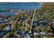 An aerial view shows a home situated in a residential area with waterfront access and city views at 3165 Renatta Dr, Belleair Bluffs, FL 33770