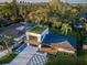 An aerial perspective highlights this modern home's rooftop turf, distinctive driveway, and verdant surroundings at 3165 Renatta Dr, Belleair Bluffs, FL 33770