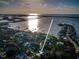 Aerial view shows location of house relative to the water and area bridges at 3165 Renatta Dr, Belleair Bluffs, FL 33770