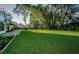 Lush backyard with mature trees and modern design at 3165 Renatta Dr, Belleair Bluffs, FL 33770