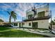 Contemporary home featuring an architectural staircase and a beautifully landscaped backyard at 3165 Renatta Dr, Belleair Bluffs, FL 33770