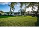 Lush backyard with ample green space and mature trees at 3165 Renatta Dr, Belleair Bluffs, FL 33770