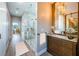 Modern bathroom features a glass shower with marble accents and a wood vanity with marble countertop at 3165 Renatta Dr, Belleair Bluffs, FL 33770