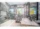 Beautiful bathroom showcases modern vanity, marble walls, and glass-enclosed tub and shower at 3165 Renatta Dr, Belleair Bluffs, FL 33770