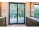 Elegant bathroom with double vanities and a large window overlooking the deck at 3165 Renatta Dr, Belleair Bluffs, FL 33770