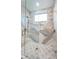 Modern bathroom with a glass-enclosed shower and stylish tile work at 3165 Renatta Dr, Belleair Bluffs, FL 33770