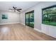A relaxing bedroom features new hardwood floors, a ceiling fan, and great light at 3165 Renatta Dr, Belleair Bluffs, FL 33770