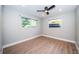 Empty bedroom featuring hardwood floors, large windows, fresh paint, and recessed lights at 3165 Renatta Dr, Belleair Bluffs, FL 33770