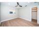 Neutral bedroom with hardwood floors, large window, recessed lighting, and closet at 3165 Renatta Dr, Belleair Bluffs, FL 33770