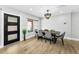 Contemporary dining room with modern light fixture and wood flooring at 3165 Renatta Dr, Belleair Bluffs, FL 33770