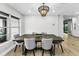 A modern dining room is brightened by natural light from the window at 3165 Renatta Dr, Belleair Bluffs, FL 33770