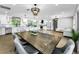 Open concept dining area and kitchen with stainless appliances and a large island at 3165 Renatta Dr, Belleair Bluffs, FL 33770