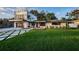 A modern two-story home boasts clean lines, a spacious front yard, and a unique driveway design with green accents at 3165 Renatta Dr, Belleair Bluffs, FL 33770