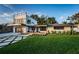 Modern home with two-story design, large windows, a spacious deck, and unique geometric driveway for curb appeal at 3165 Renatta Dr, Belleair Bluffs, FL 33770