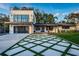 Striking modern two-story home with a unique driveway design and professional landscaping at 3165 Renatta Dr, Belleair Bluffs, FL 33770