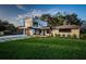 Contemporary home featuring lush front lawn, modern design, and a spacious driveway at 3165 Renatta Dr, Belleair Bluffs, FL 33770
