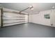 Spacious two-car garage with painted floor and ample lighting at 3165 Renatta Dr, Belleair Bluffs, FL 33770