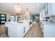 Spacious kitchen with marble counters, a large island, seating, and open sightlines to the rest of the house at 3165 Renatta Dr, Belleair Bluffs, FL 33770