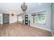 Spacious open-concept living area featuring hardwood floors, modern lighting and large windows at 3165 Renatta Dr, Belleair Bluffs, FL 33770