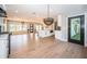 Spacious open-concept living area featuring wood floors, recessed lighting, and a modern kitchen provides an inviting atmosphere at 3165 Renatta Dr, Belleair Bluffs, FL 33770