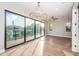 Bright living room featuring hardwood floors, modern lighting, and large windows with scenic views at 3165 Renatta Dr, Belleair Bluffs, FL 33770