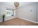 Inviting living room boasting natural light, hardwood floors, and modern light fixture at 3165 Renatta Dr, Belleair Bluffs, FL 33770