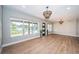 Bright and airy living room with hardwood floors, large windows, and modern lighting at 3165 Renatta Dr, Belleair Bluffs, FL 33770