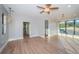 Bright living room featuring hardwood floors, modern lighting, and large windows with scenic views at 3165 Renatta Dr, Belleair Bluffs, FL 33770