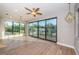 Bright living room featuring hardwood floors, modern lighting, and large windows with scenic views at 3165 Renatta Dr, Belleair Bluffs, FL 33770