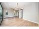 Spacious living room with hardwood floors, modern lighting, and an open doorway at 3165 Renatta Dr, Belleair Bluffs, FL 33770