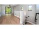Spacious loft area with wood floors, natural light, and access to the outdoors via large sliding glass doors at 3165 Renatta Dr, Belleair Bluffs, FL 33770
