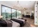 Spacious main bedroom with hardwood floors, a large window, and stylish furniture at 3165 Renatta Dr, Belleair Bluffs, FL 33770