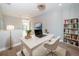 Modern office with a sleek desk, bookshelf, and a large window, situated on the upper level of the home at 3165 Renatta Dr, Belleair Bluffs, FL 33770
