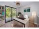 Stylish office space with a sleek desk, bookshelf, and sliding doors leading to a private outdoor deck at 3165 Renatta Dr, Belleair Bluffs, FL 33770