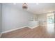 Open room featuring wood flooring, recessed lighting, and access to other areas of the home with ample sunlight at 3165 Renatta Dr, Belleair Bluffs, FL 33770