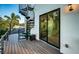 Spiral staircase and wooden deck lead to a door to the home's interior at 3165 Renatta Dr, Belleair Bluffs, FL 33770