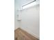 Walk-in closet with custom shelving and wooden floors is ready for storage at 3165 Renatta Dr, Belleair Bluffs, FL 33770