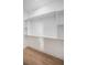 A well-organized walk-in closet with built-in shelving and wooden floors is ready for storage at 3165 Renatta Dr, Belleair Bluffs, FL 33770