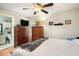 Cozy bedroom with neutral walls, wood furniture, and a ceiling fan at 3203 Doe Ct, Brandon, FL 33511