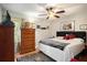 Bedroom with neutral walls, wood furniture, ceiling fan, and patterned rug at 3203 Doe Ct, Brandon, FL 33511