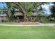 Exterior shot showcasing the lawn and facade of the property surrounded by mature shade trees at 3203 Doe Ct, Brandon, FL 33511