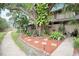 Well-maintained front yard with mature tree, mulch, and decorative stone border, enhancing curb appeal at 3203 Doe Ct, Brandon, FL 33511