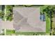 A bird's-eye view reveals a home's roof, screened patio, and verdant surroundings at 32242 Summerglade Dr, Wesley Chapel, FL 33545