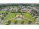 Aerial view of a neighborhood park with playground, basketball court, and walking paths amid lush greenery at 32242 Summerglade Dr, Wesley Chapel, FL 33545