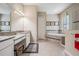 Bathroom with double vanity, large soaking tub, and glass-enclosed shower at 32242 Summerglade Dr, Wesley Chapel, FL 33545